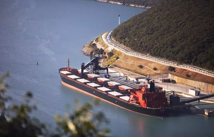 Birds eye view of Siwertell ship unloader unloading coal from a ship 